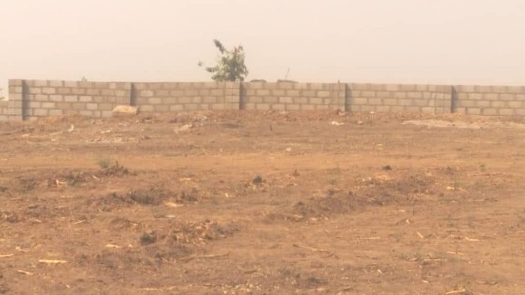 Buying land in Nigeria from abroad – Nigerians in the diaspora reviewing property documents online.